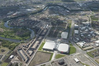 Oblique aerial view of the construction of the Glasgow Commonwealth games site, looking to the SSW.