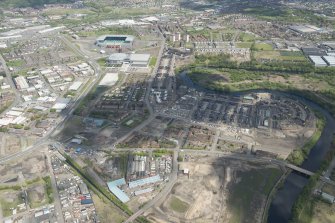 Oblique aerial view of the construction of the Glasgow Commonwealth games site, looking to the NNE.