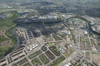 Oblique aerial view of the construction of the Glasgow Commonwealth games site, looking to the S.