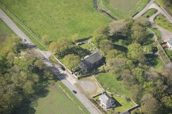 Oblique aerial view of Foveran Parish Church and Manse, looking to the SW.