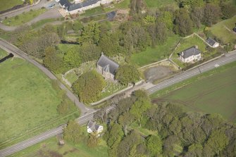 Oblique aerial view of Foveran Parish Church and Manse, looking to the NW.