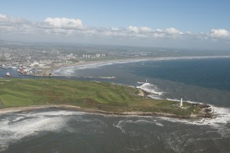 General oblique aerial view of Aberdeen Bay centred on Girdleness Lighthouse and Balnagask Golf Course, looking to the NW.