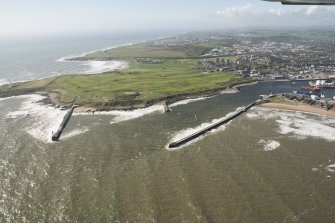 General oblique aerial view of Girdleness centred on Girdleness Lighthouse and Balnagask Golf Course, looking to the SSW.