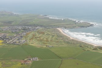 General oblique aerial view of Cruden bay centred on Cruden Bay Golf Courses, looking to the NE.