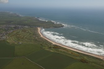 General oblique aerial view of Cruden bay centred on Cruden Bay Golf Courses, looking to the NNE.