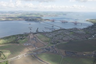 General oblique aerial view of the River Forth centred on the construction of the new  Forth Bridge crossing, looking to the ENE.