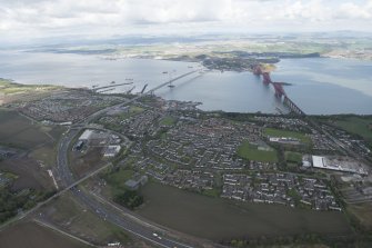 General oblique aerial view of the River Forth centred on the construction of the new  Forth Bridge crossing, looking to the N.