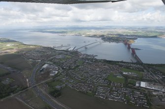General oblique aerial view of the River Forth centred on the construction of the new  Forth Bridge crossing, looking to the WNW.