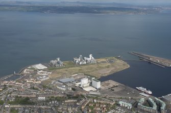 General oblique aerial view of Leith Docks centred on the Caledonia Flour Mills, looking to the N.