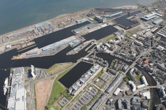 General oblique aerial view of Leith Docks centred on Victoria Docks, looking to the NE.