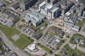 Oblique aerial view of building construction of the Elizabeth Montgomerie Foundation within Aberdeen Royal Infirmary, looking to the NW.