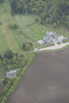 General oblique aerial view of Dunecht House, chapel and stable blocks, looking to the S.