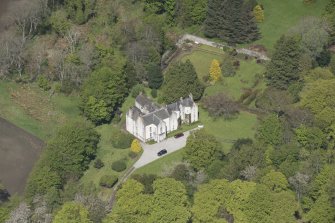 Oblique aerial view of Corsindae House with adjacent walled garden, looking to the NNE.