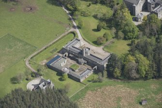 Oblique aerial view of Cluny Castle stable blocks, looking to the ESE.