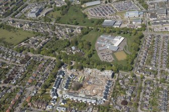 General oblique aerial view of the construction site of Oakhill Grange Housing Estate on the site of the former Oakbank Approved School with Beechwood School adjacent, looking to the NNW.