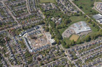 General oblique aerial view of the construction site of Oakhill Grange Housing Estate on the site of the former Oakbank Approved School with Beechwood School adjacent, looking to the NW.