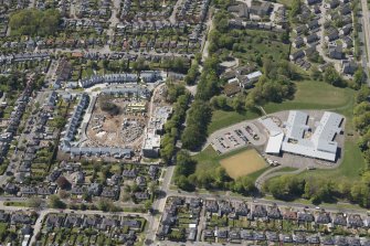 General oblique aerial view of the construction site of Oakhill Grange Housing Estate on the site of the former Oakbank Approved School with Beechwood School adjacent, looking to the W.