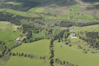 General oblique aerial view of Cluny Castle estate centred on Cluny Castle, looking to the NNW.
