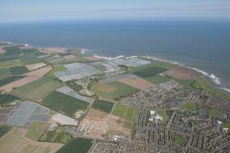 General oblique aerial view of Carlingheugh Bay centred on Seaton House, looking to the E.