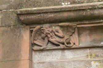 Detail of carved creature on wall between stair tower and main entrance