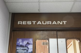 Interior. Detail of signage on Restaurant entrance.