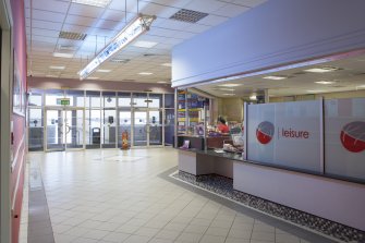 Interior. View from South of reception desk and concourse into centre looking towards entrance doors.