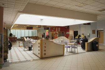 Interior. View from South East across central concourse, showing cafe area and glazed lightwell.