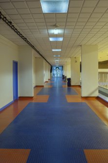 Interior. View looking along the central corridor, with viewing balcony to main sports hall viewing to right, taken from west.