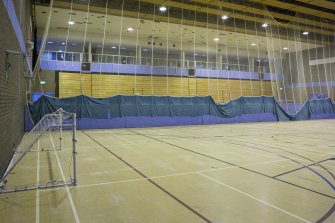 Interior. View from south west, looking across the main sports hall to the viewing balcony and retractable seating.