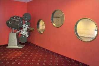 Interior view of the Magnum Leisure Centre, Irvine showing detail of old cinema projector and porthole opening within theatre foyer.