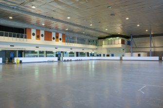 Interior. View from south west looking across the ice rink to the viewing balcony and cantilevered dance studio.