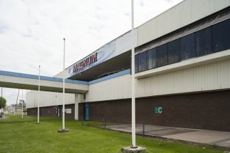 View from ground level looking up to the footbridge and main entrance of the Magnum Centre, taken from west.
