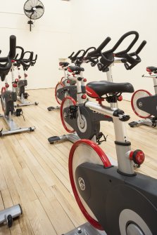 Interior. View of "spin'' class bikes within former squash court.