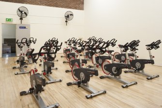 Interior. View of "spin'' class bikes within former squash court.