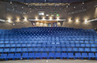 Interior. View from the stage, looking up the raked seating of the theatre auditorium.