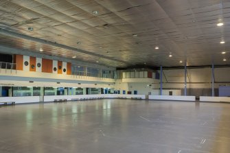 Interior. View from south west, looking across the ice rink to the viewing balcony and cantilevered dance studio.