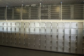 Interior. Detail of lockers and Curling sessions board within the ice rink.