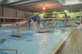 Interior. View looking south east across swimming pool hall, with pool extension beyond.