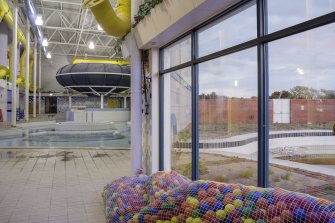 Interior. View looking east within the extension to the swimming pool hall, with windows to the unused exterior pool.