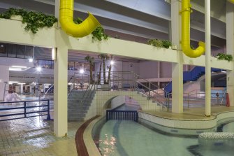 Interior. View looking north from the pool extension, through the structure of the former back wall of the swimming pool hall.