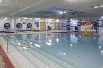 Interior. View looking east across the splash pool, with lightwell to main concourse above.