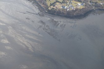 Oblique aerial view of the remains of the kelp grids and fish trap in Loch Portree, looking to the W.