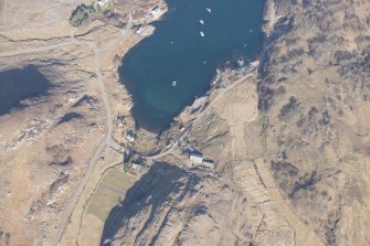 Oblique aerial view of Ardleshaig centred on the remains of the fish trap, looking NW.