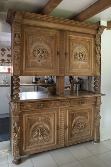 Detail of antique oak cabinet between dining room and kitchen.