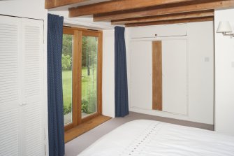General view of master bedroom showing french doors to the garden.