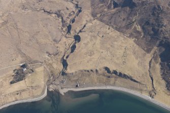 Oblique aerial view of the remains of the township buildings, field boundaries and cultivation, looking S.