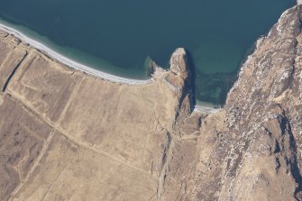 Oblique aerial view of Dun Canna fort and the adjacent fish trap, looking W.