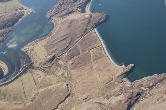 General oblique aerial view of Dun Canna fort and the adjacent fish trap, looking SW.