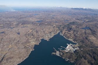 General oblique aerial view of Lochinver with Quinag in the distance, looking NE.