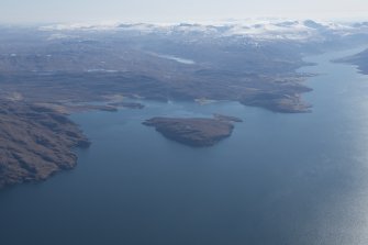 General oblique aerial view with Isle Martin and Loch Kanaird in the middle distance and Loch Broom and Ullapool beyond, looking SE.